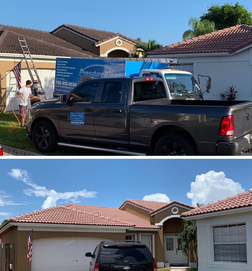 Pressure washing service in action on a residential home with a truck and ladder visible.
