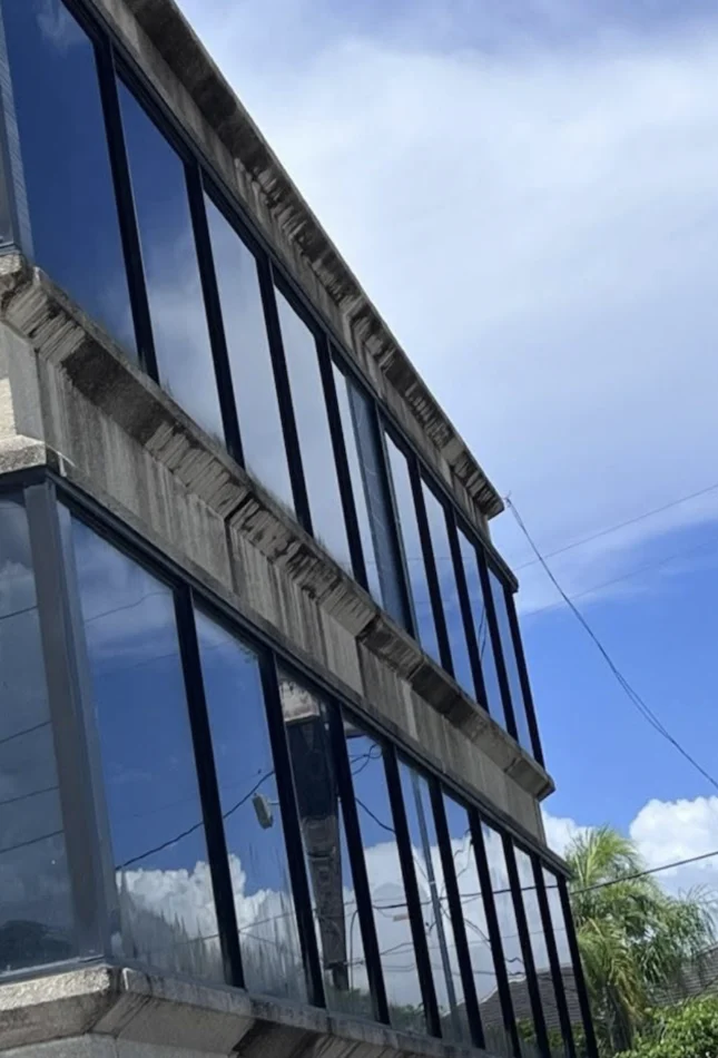 Drone softwashing a Coral Gables building.