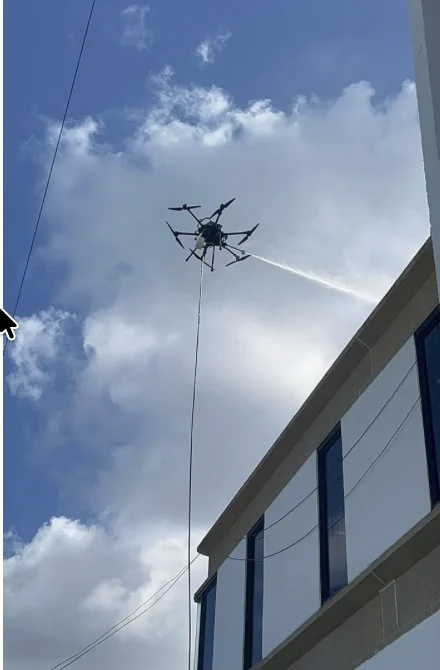Cleaning drone working beside the Coral Gables building