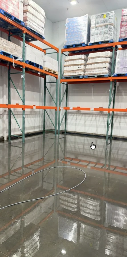Another view of the Costco cooler floor beneath tall pallet racks