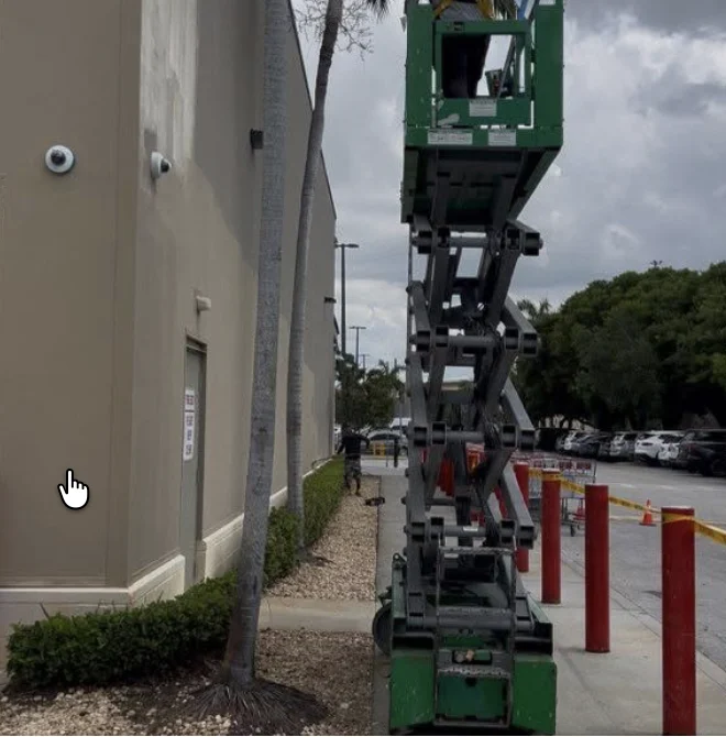 Lift positioned beside the Costco exterior during restoration work