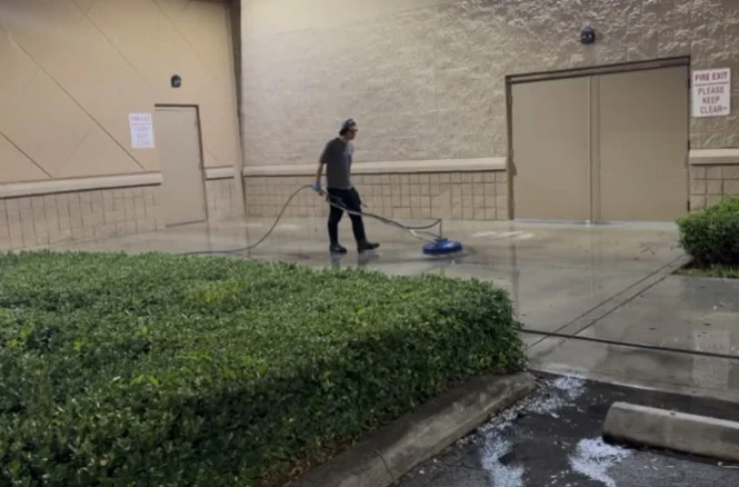 Technician cleaning the exterior walkway during the overnight Costco project