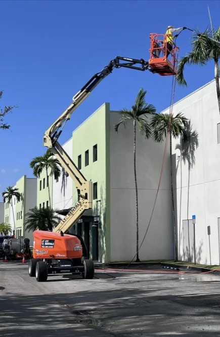 Boom lift providing access to an industrial facade in Medley