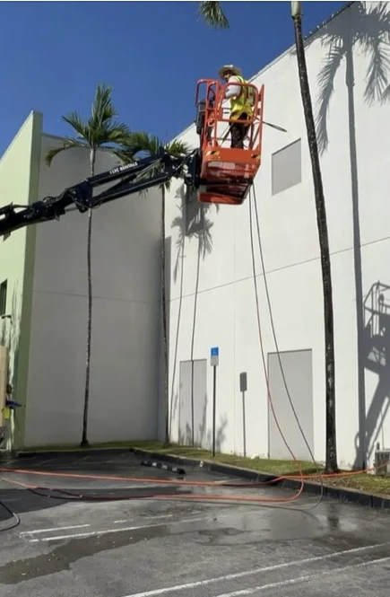 Elevated cleaning work on an industrial building facade in Medley