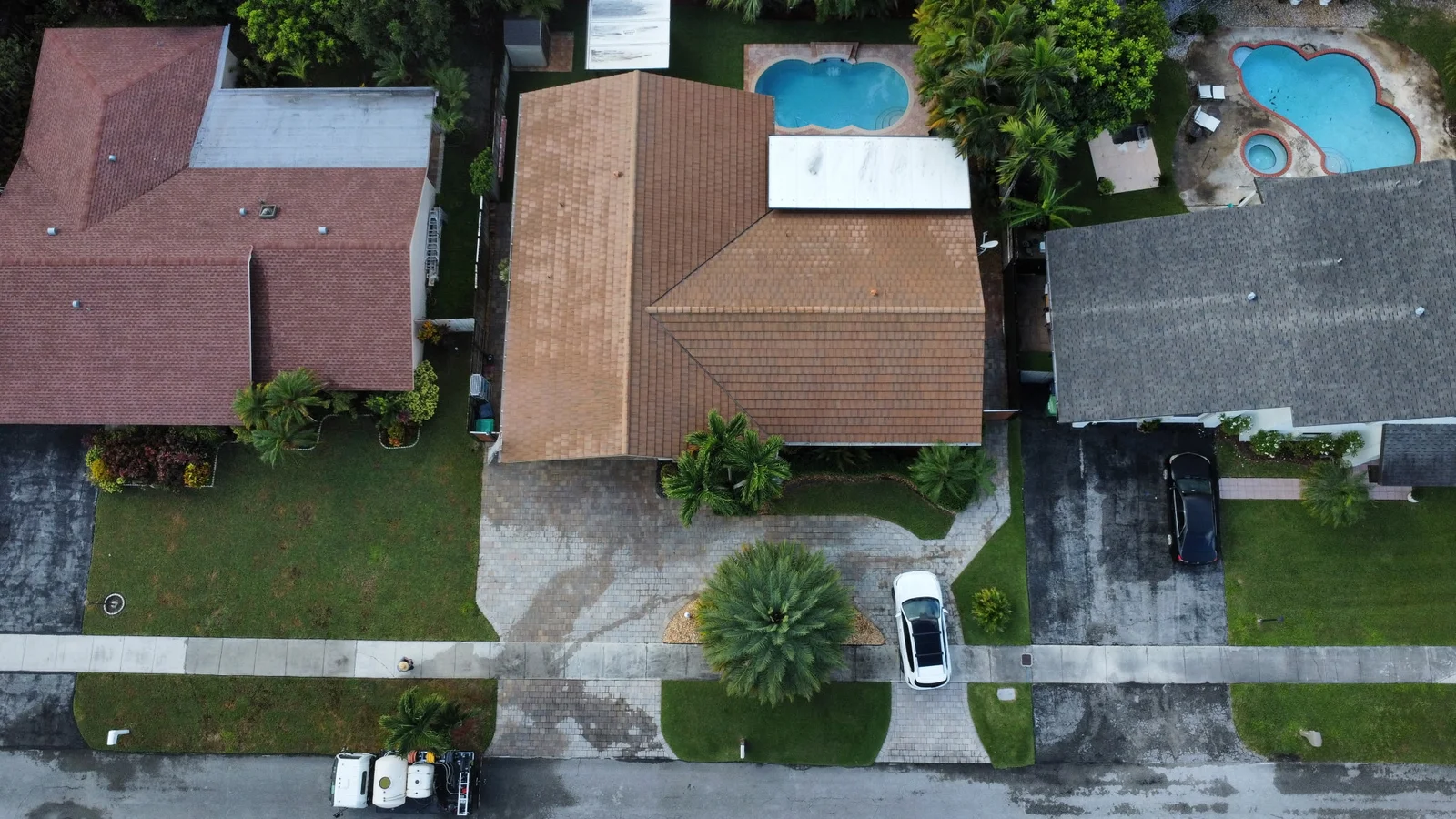 Aerial view of the same lighter-colored residential roof after washing
